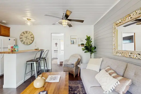 Open Living & Dining Area View Showing Sofa, Coffee Table & Kitchen Counter