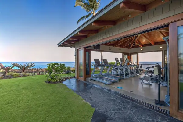Ocean-View Fitness Center with Open Sliding Doors & Cardio Equipment