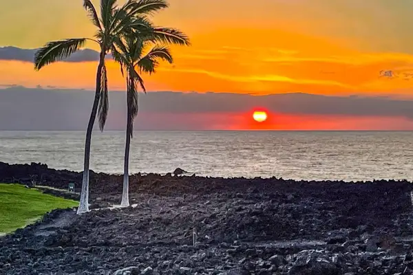 Experience Hawaii's picturesque sunsets as vibrant shades of orange, pink, and blue paint the sky above the Pacific Ocean.