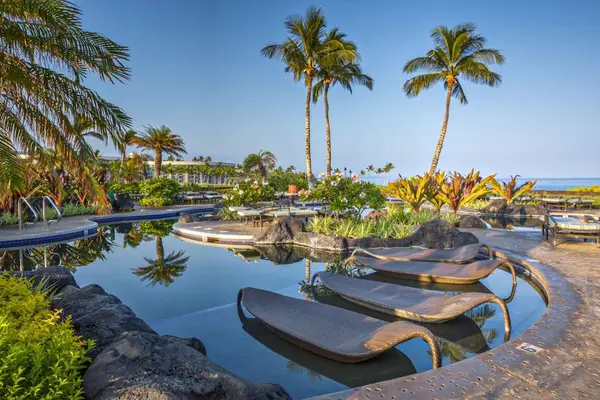 Resort Swimming Pool with In-Water Sun Loungers & Ocean Horizon