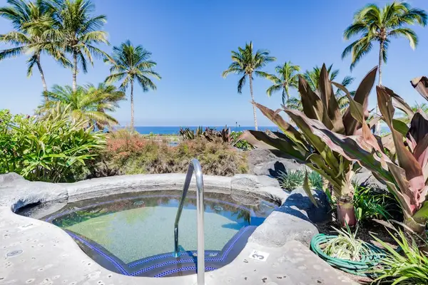 In-Ground Ocean-View Hot Tub Surrounded by Tropical Landscaping