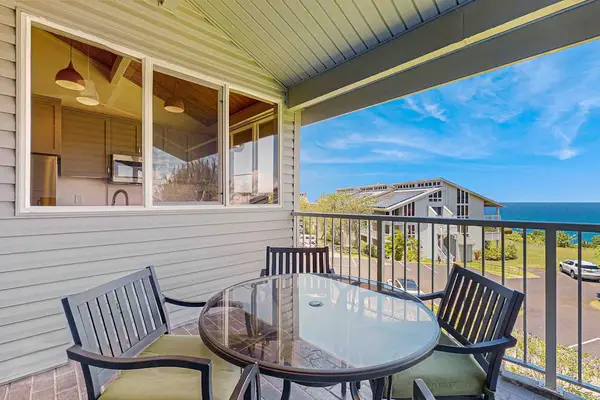 Large lanai with tropical views and seating for four.