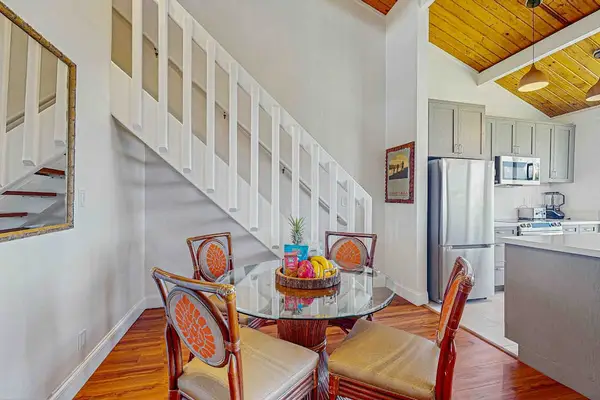 Dining room with seating for four open to the kitchen.