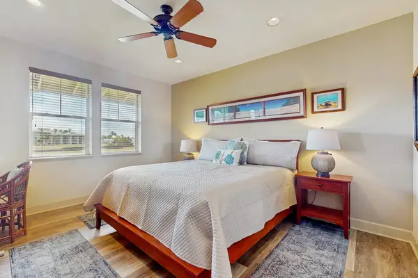 Bright Primary Bedroom featuring Wooden Bedframe & Ceiling Fan