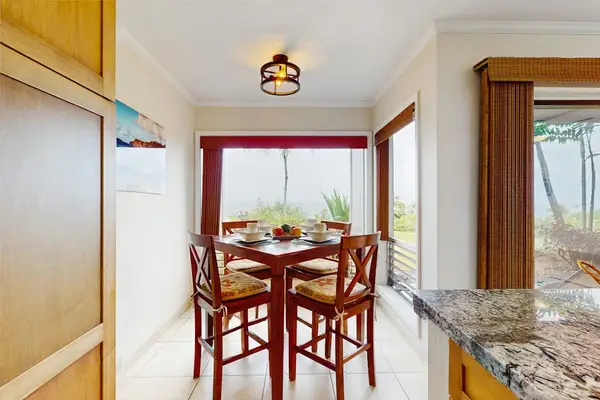 Bright dining area encourages shared meals beside windows and greenery