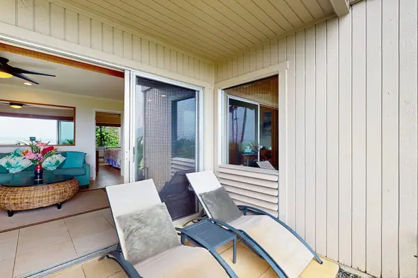 Covered patio showcases tiled flooring, bistro seating, and mountain views