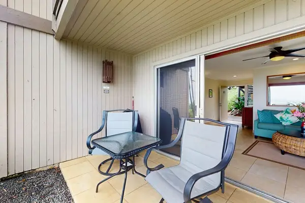 Patio seating offers a charming spot beside landscaped lawns