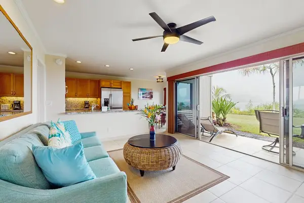 Contemporary living room offers conversational seating beneath distinctive vaulted ceilings
