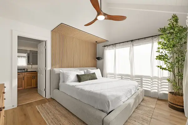 Cozy bedroom with large windows and abundant natural light