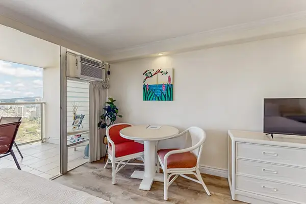 Designed for convenience, the studio layout includes a two-person dining nook, a flat-screen TV, and an air conditioning unit.