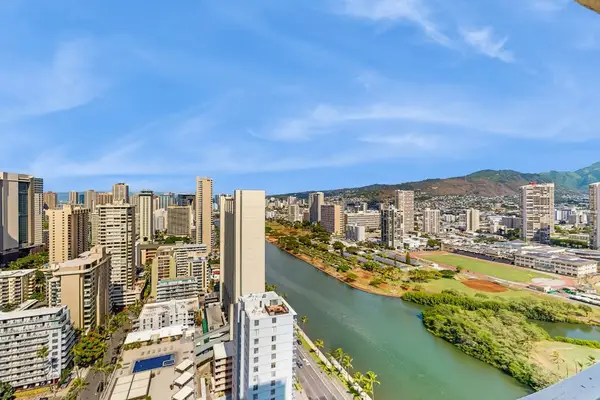 Take in sweeping high-floor views of the Ala Wai Canal, vibrant city landscape, and tropical mountains.