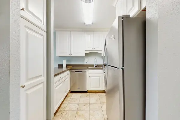 Cozy kitchen with everything you need for home-cooked meals, opening to the dining and living areas with abundant natural light from the sliding doors to the lanai.