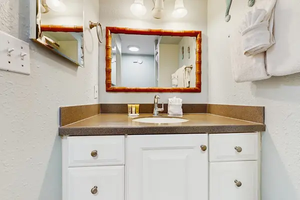 Bright, updated bathroom featuring a spacious tiled walk-in shower and modern finishes.