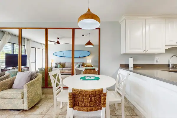 Dining table for four in an open-concept space that flows seamlessly into the living room.