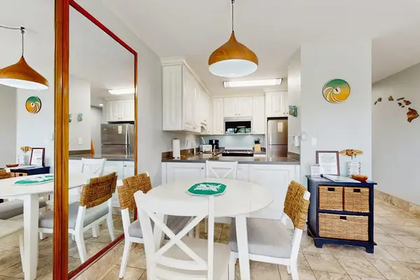 Dining table for four in an open-concept space that flows seamlessly into the living room.