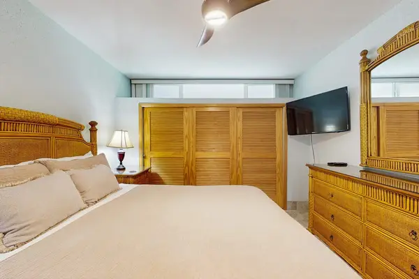 Comfortable bedroom with a king bed and flat-screen TV for restful nights and relaxing mornings.