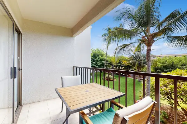 Private lanai with seating for two overlooking lush tropical paradise—perfect for morning coffee or sunset relaxation.