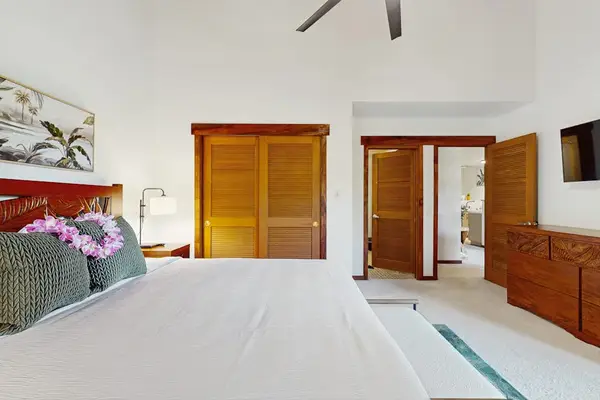 Bright Primary Bedroom With Vaulted Ceilings