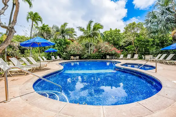 Sparkling Resort Pool Surrounded By Palms