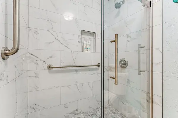 Master bedroom with double sinks and large walk-in shower.