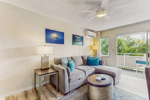 Living room with views of the tropical foliage from the lanai.