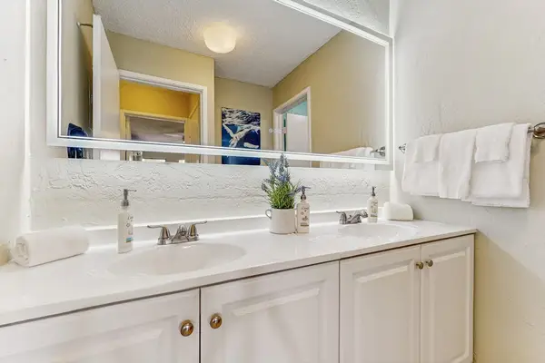 Master bedroom with double sinks and large walk-in shower.