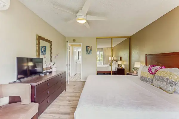 Newly remodeled condo with king bed, ceiling fan and light from the lanai.  There is a flat screen tv while you unwind.
