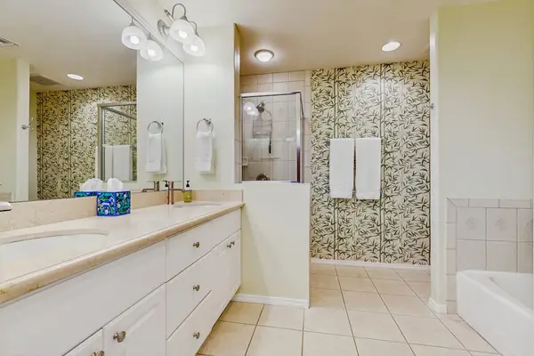 Spa-style bathroom with dual vanities