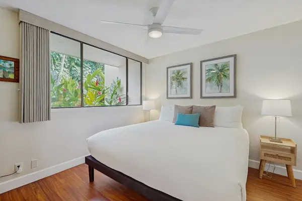 Rest easy in this bright, airy bedroom decorated with soothing coastal accents and modern bedside lighting