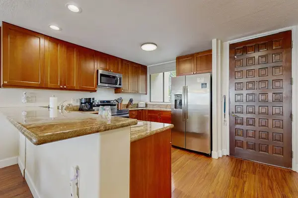 Cook with ease in the fully equipped kitchen, featuring stainless steel appliances and ample prep space
