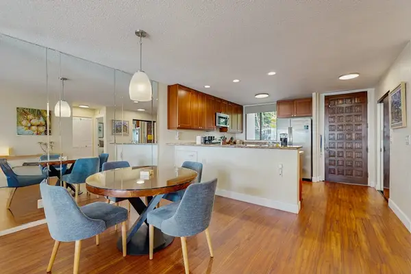 ​A seamless transition from the stylish dining space to the fully equipped, modern kitchen