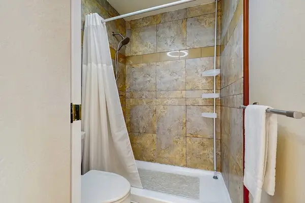 Unwind with a relaxing soak or a refreshing shower in the beautifully tiled tub-shower combo