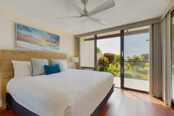 Relax in style, this airy, coastal-themed bedroom offers seamless indoor-outdoor flow