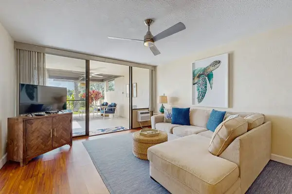 Relax in the bright, open-concept living area featuring comfortable seating and seamless indoor-outdoor flow