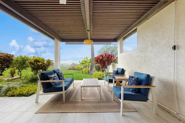Relax in style on the spacious, covered patio featuring comfortable outdoor seating