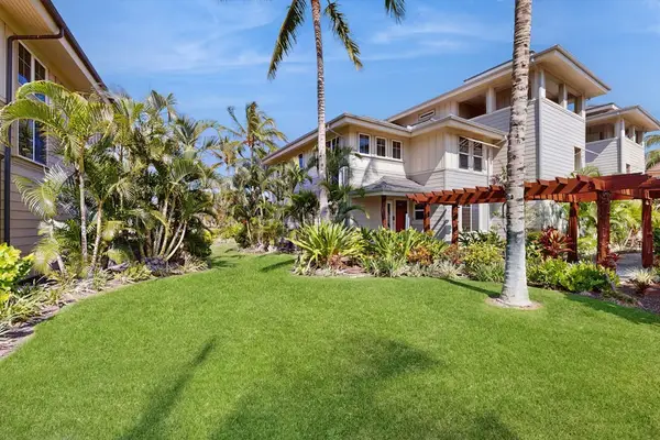 Lush oceanfront lawn with tropical landscaping