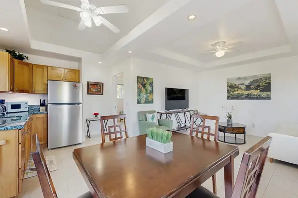 Dining room with table for four and open to the kitchen and living room.