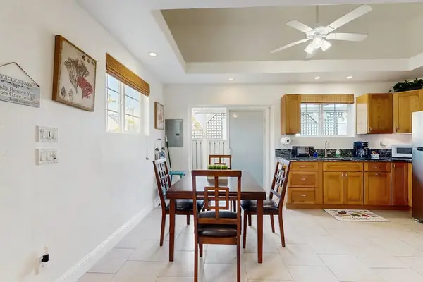 Dining room with a table for four open to the kitchen.