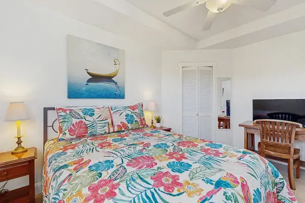 Master bedroom with queen bed with a flat screen tv.