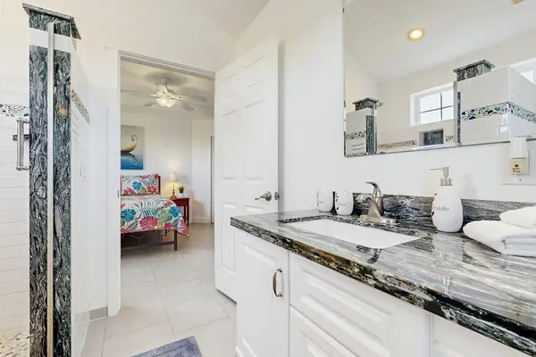 Master bathroom with a tiled walk-in shower.