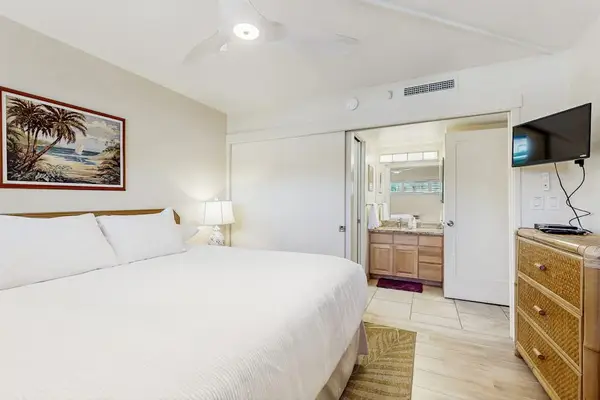 Master bedroom with king bed, flat screen tv and en-suite bathroom.