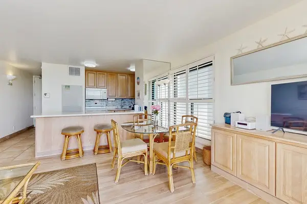 Dining room with seating for four and extra seating at the kitchen counter.
