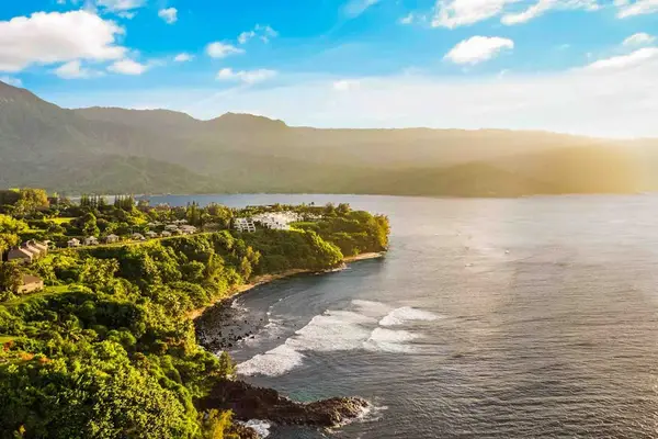 Scenic coastline framed by lush mountains and the Pacific Ocean