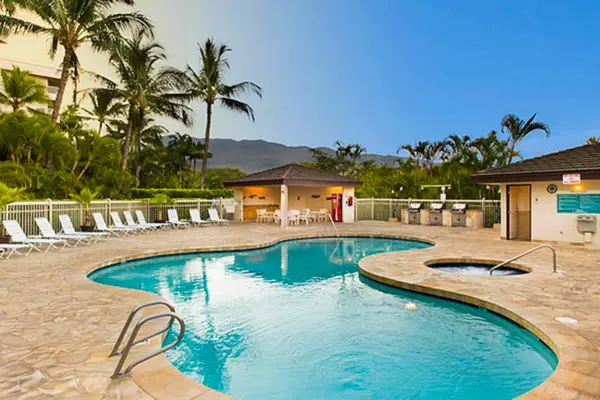 Relax by the sparkling resort pool surrounded by tropical scenery