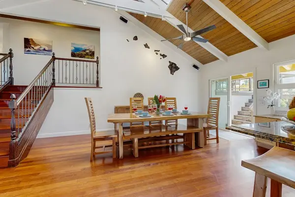 Gather around the dining table with seating for the whole family beneath soaring cathedral ceilings and skylights that fill the space with natural light.