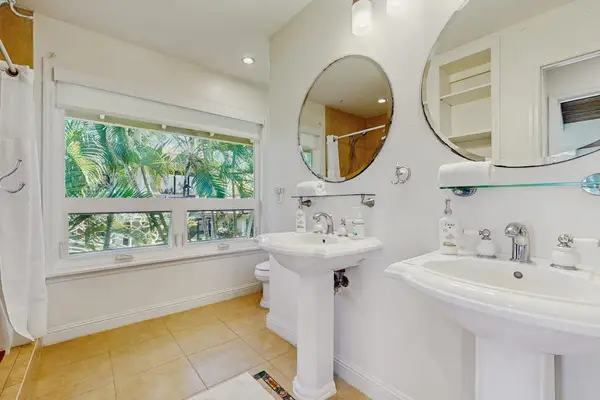 Full bathroom with double pedestal sinks