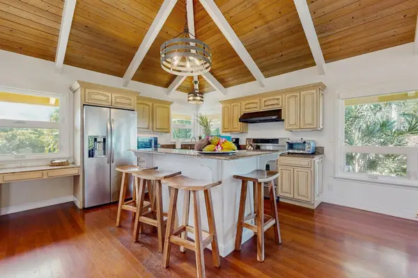 The kitchen is equipped with plenty of equipment to cook delicious meals, as well as luxuries like a kitchen island and a brand new stainless steel French door refrigerator.