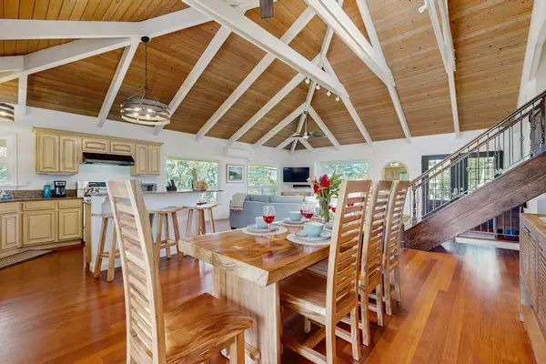 Gather around the dining table with seating for the whole family beneath soaring cathedral ceilings and skylights that fill the space with natural light.