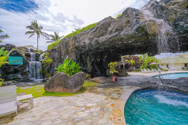 Tropical Waterfall Pool With A Serene Island Retreat