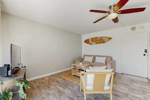 Relax comfortably in the living room with a ceiling fan keeping the space cool.